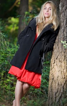 beautiful young girl with a red dress in the nature