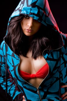 beautiful brunete girl in an aggressive attitude with a dark background