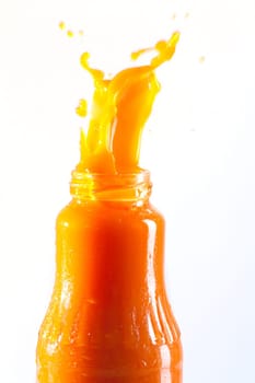 Carrot juice squirts out of the bottle