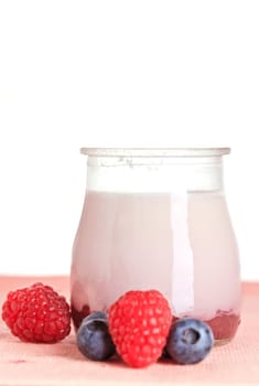 Delicious glass yogurt and fresh raspberry and blueberry. Shallow depth of field