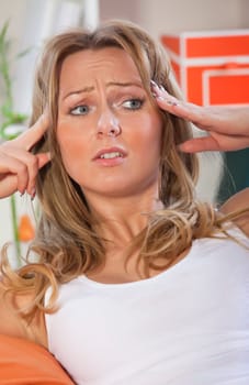 woman with headache holding her head with both hands