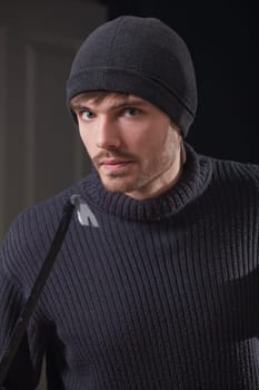 burglar with crowbar breaking into the house