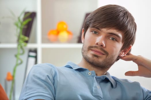 portrait of man resting on sofa at home