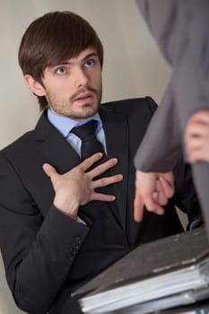 angry boss giving lots of paperwork to his assistant