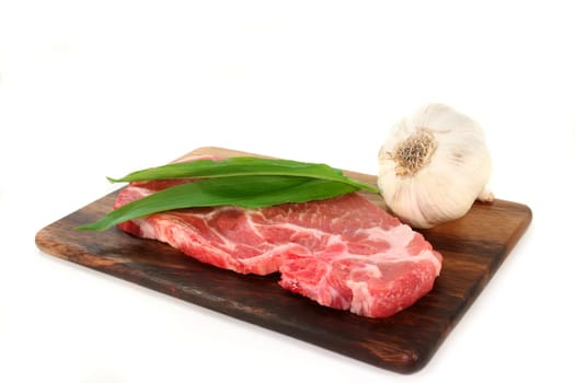 a pork neck chop against a white background