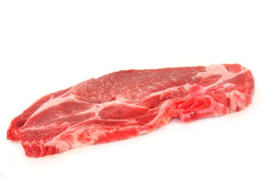 a pork neck chop against a white background
