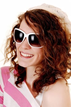 An young happy woman in a striped sweater a knitted hat and  sunglasses standing for white background.