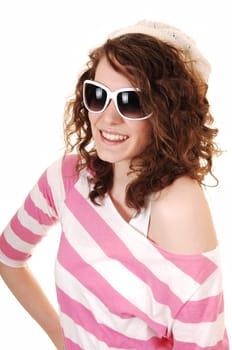 An young happy woman in a striped sweater a knitted hat and  sunglasses standing for white background.