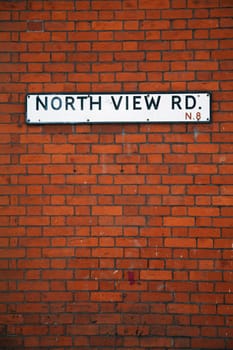 Street sign on an English brick wall