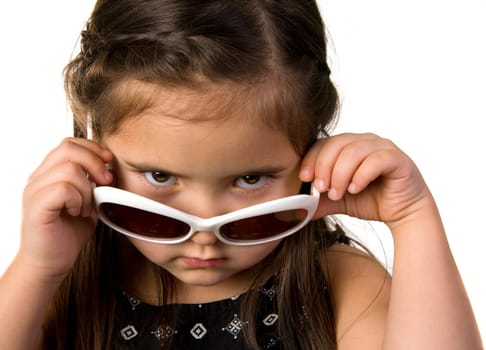 Portrait of a beautiful little girl in sunglasses. Isolated on white background