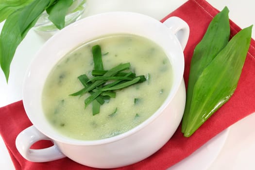 a cup of wild garlic soup with fresh wild garlic