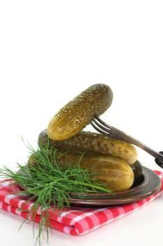 Pickles and dill on a plate
