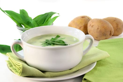 a cup of wild garlic soup with fresh wild garlic