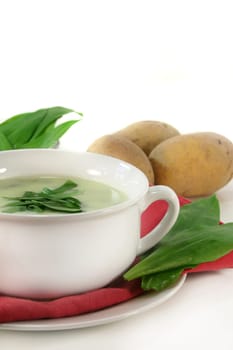 a cup of wild garlic soup with fresh wild garlic