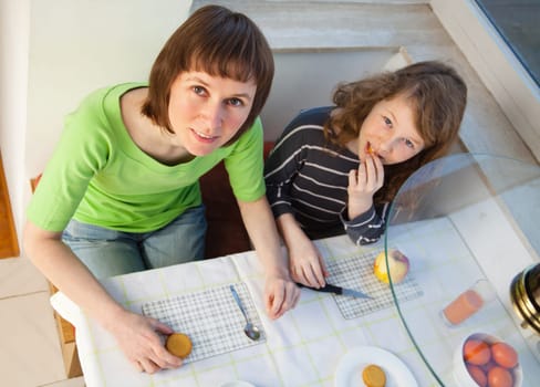 Daughter and her mom having a breakfast together. High angle view.