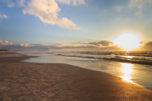 reflection of the sun at sunrise on the beach