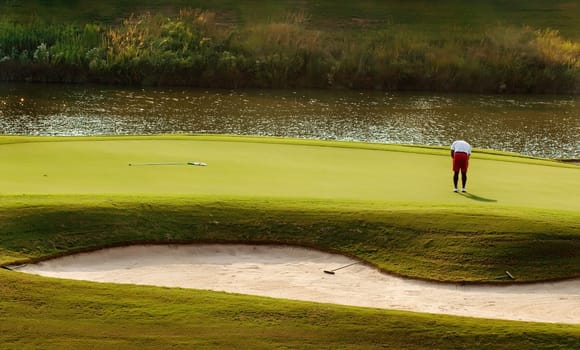 Image of a golfer putting on green
