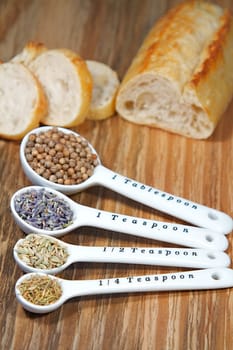 Old table-top selection of herbs and grains in measuring spoons