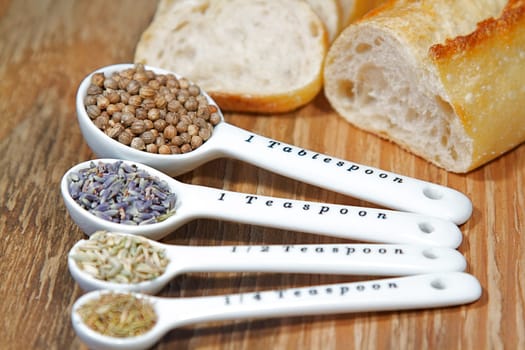 Old table-top selection of herbs and grains in measuring spoons