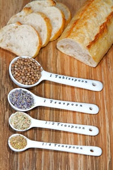 Old table-top selection of herbs and grains in measuring spoons