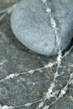 Vintage antique necklace closeup on a natural stone background