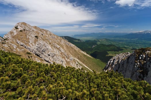 mountain top and clouds in a blue sky, Piatra Craiului Mountains, Romania