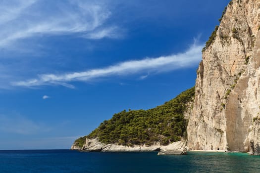 a mountain slope near a blue sea