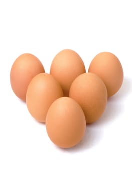 Six fresh eggs in a triangle shape, isolated on white background