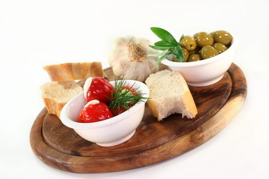 stuffed pepperoni and green olives in white bowls