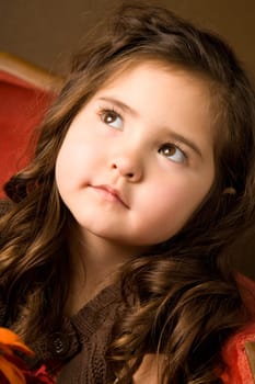 Portrait of a beautiful little girl in happy thoughts