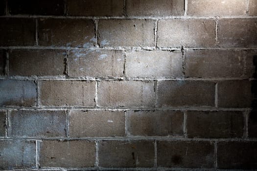 Fragment of block wall with spotlight lighting