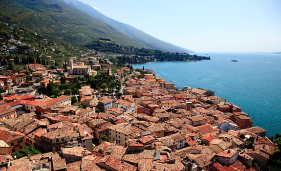 View over Lake Garda over the tiled roofs of Malcesine