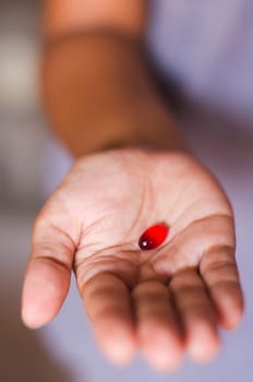 a red tablet is handed out by a woman.