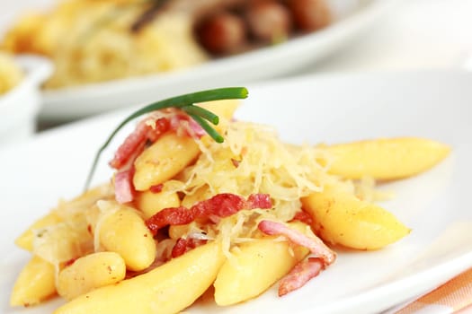 German traditional meal - Rolled noodle with sour cabbage and bacon