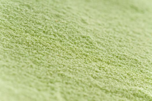 Close-up of green sand with oblique sharpness gradient