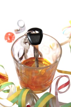whiskey glass with car keys on white background depicting drunk driving and addictions can kill
