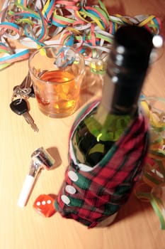 bottle dressed in jacket warmer with car keys on office desk depicting drunk driving and addictions can kill