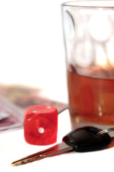 whiskey glass with car keys and cash on white background depicting gambling with drunk driving and addictions can kill