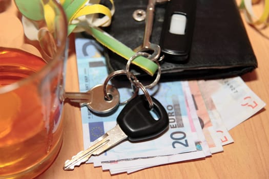 wallet whiskey glass and keys at office party on desk depicting dont drink and drive