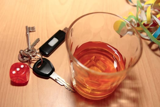 whiskey glass and keys and dice on office desk depicting dont gamble with your life
