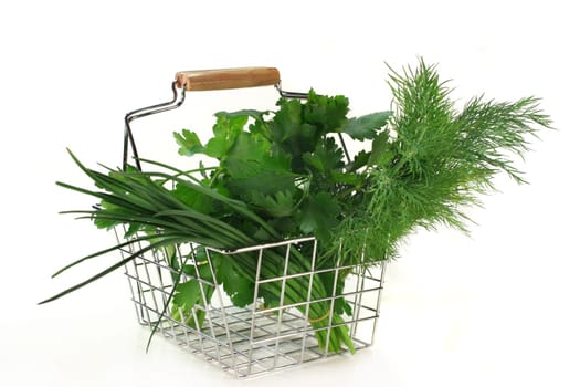 Various kitchen herbs against white background