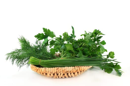 Various kitchen herbs against white background