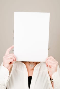 Face of a mature woman covered by small canvas as an upper body portrait