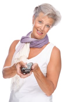 Studio shot of an active senior woman with remote control