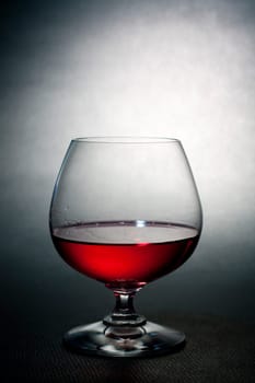 Luxury red liqueur on crystal balloon glass