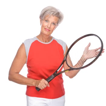 Studio shot of an active senior woman with tennis racket