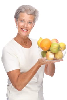 Studio shot of an active senior woman with fruit