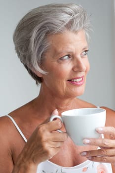 Active senior woman in the morning with a cup of coffee