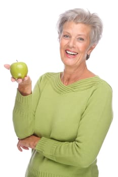 Studio shot of an active senior woman with an apple