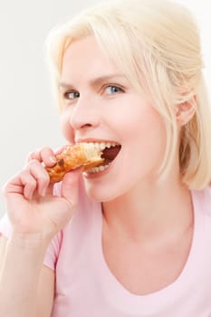 Young and blonde woman sitting at a breakfast table